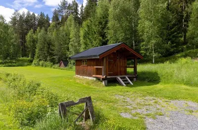 a small cabin in the middle of a field at Skogcamping in Bjørnstad