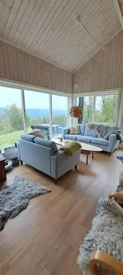 a large living room with two couches and windows at Steinstølen by Norgesbooking - cabin with a lovery view in Hol