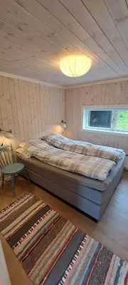a bedroom with a large bed in a room at Steinstølen by Norgesbooking - cabin with a lovery view in Hol