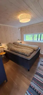 a bedroom with a large bed in a room at Steinstølen by Norgesbooking - cabin with a lovery view in Hol