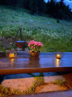 a picnic table with flowers and lights on it at Cozy family cabin with stunning location on Golsfjellet in Golsfjellet