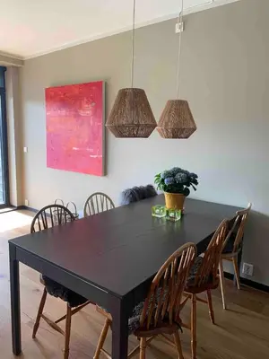 a dining room with a black table and chairs at Nydelig leilighet på Geilo i Highland fjellandsby in Geilo