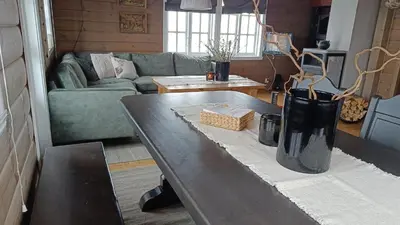 a living room with a table and a couch at Hytte i Myrkdalen in Helgatun