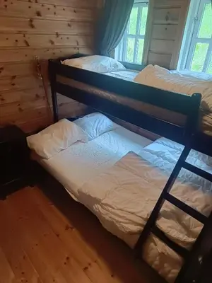two bunk beds in a room with a window at Hytte i Myrkdalen in Helgatun