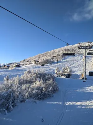 a snow covered ski slope with a ski lift at Hytte i Myrkdalen in Helgatun