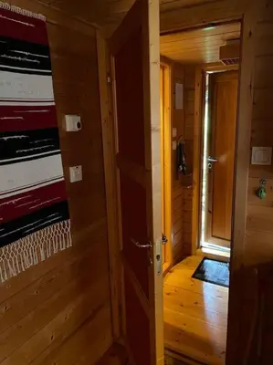 a wooden hallway with a door to a room at Cozy cabin, minimum 5 nights in Oppheim