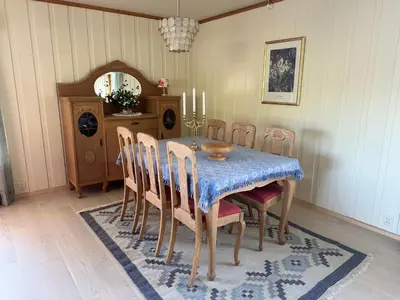 a dining room with a blue table and chairs at Villa Soltun in Ringebu