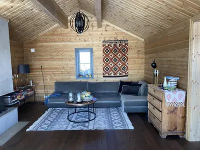 a living room with a couch and a table at New, cozy, and comfortable cabin in Geilo in Flatåker