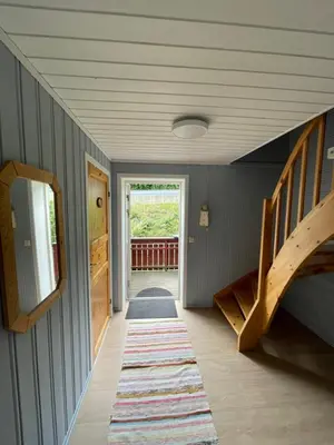 a hallway with a staircase in a house at Vågen Fjordbuer - Snekkerbua in Ravlo