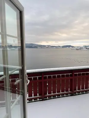 a view of the ocean from a balcony at Vågen Fjordbuer - Snekkerbua in Ravlo