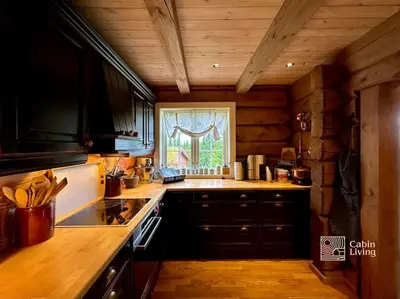 a kitchen with a stove and a sink and a window at Large log cabin at Sjusjøen with sauna, fireplace and panoramic view in Ringsaker