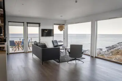 a living room with a view of the ocean at Runde Panorama - Highlight View in Runde