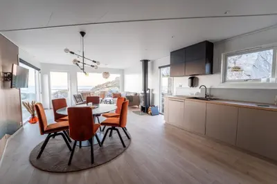 a kitchen and dining room with a table and chairs at Runde Panorama - Eden in Runde