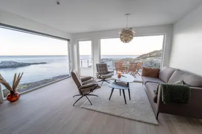 a living room with a view of the ocean at Runde Panorama - Eden in Runde