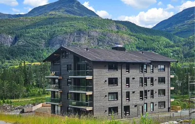 an apartment building with mountains in the background at Amazing Apartment In Hemsedal With Wifi in Hemsedal