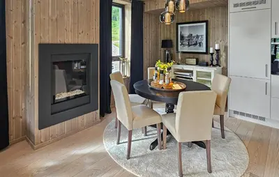 a dining room with a table and chairs and a fireplace at Amazing Apartment In Hemsedal With Wifi in Hemsedal