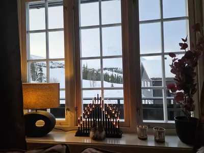 a room with a table with candles in front of a window at Gaustatoppen View Apartment in Gaustablikk