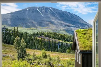 a mountain view from a window of a house at Gaustatoppen View Apartment in Gaustablikk