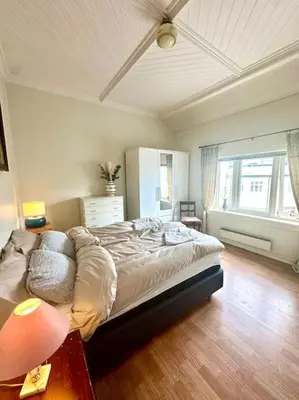 a bedroom with a large bed in a room at Authenic Art Nouveau Apartment in the city-center in Ålesund