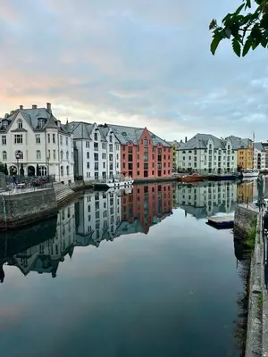 a group of buildings next to a body of water at Authenic Art Nouveau Apartment in the city-center in Ålesund