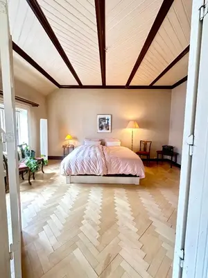 a bedroom with a bed and a wooden ceiling at Authenic Art Nouveau Apartment in the city-center in Ålesund
