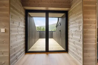 a large window in a room with wooden walls at Mountain View Apartment - penthouse in Stranda