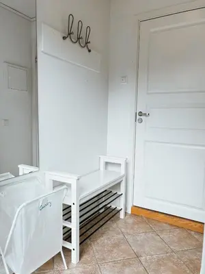 a room with a white table and a door at Newly renovated studio apartment - free parking and EV docking in Trondheim