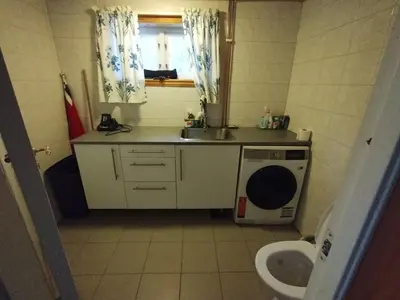 a small bathroom with a sink and a toilet at Langlete gjestehus in Gilset