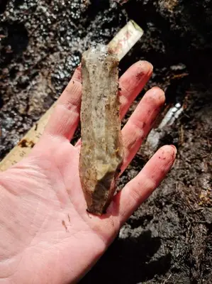a person holding a piece of rock in their hand at Boathouse in Mausund in Bogøyvær
