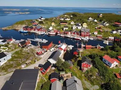 an aerial view of a small town with boats in a harbor at Boathouse in Mausund in Bogøyvær