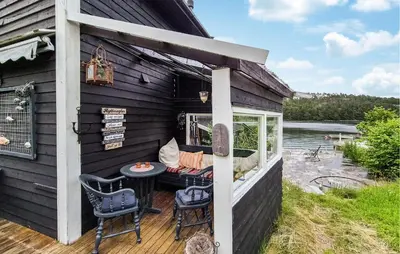 a porch of a house with a table and chairs at Stunning Home In Førde I Hordaland in Erve