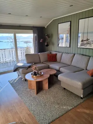 a living room with a couch and a table at Sentralt, kort vei til byens fasiliteter in Molde