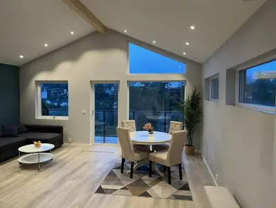 a living room with a table and chairs and a couch at Luxury apartment Bergen in Bergen