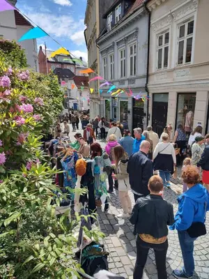 a crowd of people walking down a street at Dinbnb Apartments I Cobblestone Streets 350m from Bryggen & Fløybanen! in Bergen