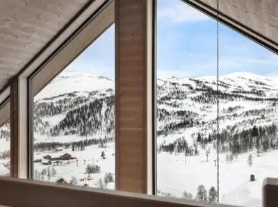 a view of a snowy mountain from a window at Flygende utsiktshytte med magisk utsikt in Sogndal