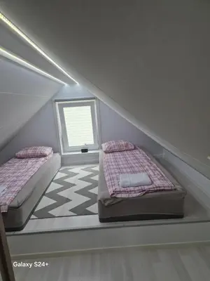 a room with two beds and a floor at APARTAMENT Duże mieszkanie W centrum Ålesund in Ålesund