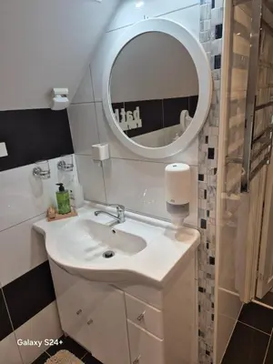 a bathroom with a sink and a mirror at APARTAMENT Duże mieszkanie W centrum Ålesund in Ålesund