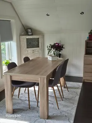 a dining room table with chairs in a room at APARTAMENT Duże mieszkanie W centrum Ålesund in Ålesund