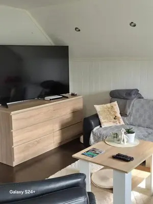 a living room with a couch and a coffee table at APARTAMENT Duże mieszkanie W centrum Ålesund in Ålesund