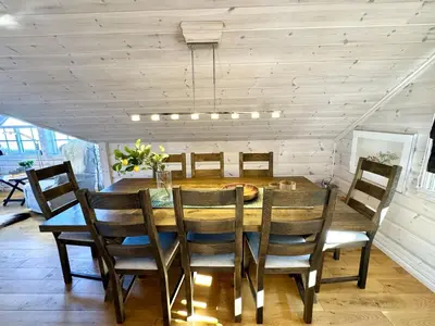 a dining room with a wooden table and chairs at Cozy Ski-In Ski-Out Apartment on Geilo, Stunning Views! in Geilo