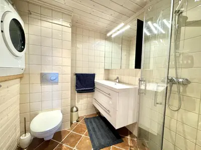 a bathroom with a toilet and a sink and a shower at Cozy Ski-In Ski-Out Apartment on Geilo, Stunning Views! in Geilo