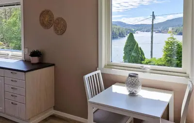 a kitchen with a table and a table and a window at 4 Bedroom Awesome Home In Ølve in Ølve