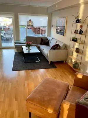 a living room with a couch and a table at seaside house with stunning sunsets & sun all day Near Trondheim in Buvika