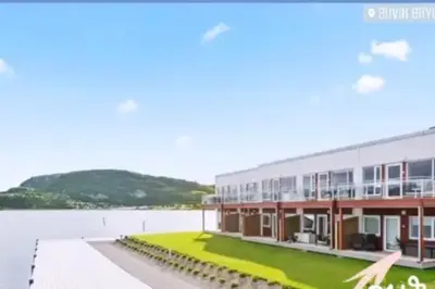 a rendering of a building next to a body of water at seaside house with stunning sunsets & sun all day Near Trondheim in Buvika