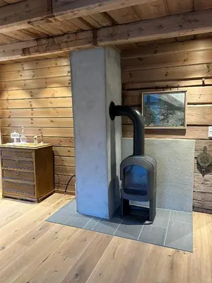 a woodburning stove in a room in a cabin at Jostedal Lodge in Jostedal