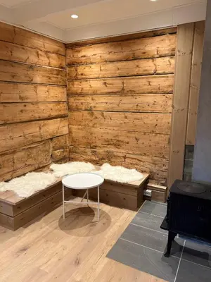 a table in a room with a wooden wall at Jostedal Lodge in Jostedal