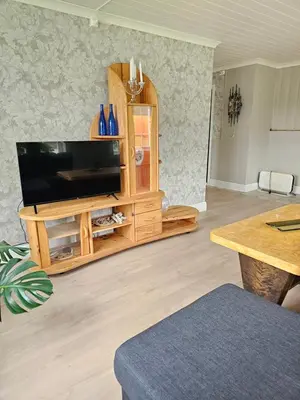 a living room with a flat screen tv on a wooden entertainment center at Familie og gruppevennlig hus 12 senger 240kvm in Oppdal