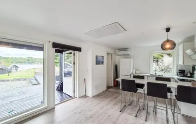a kitchen with a table and chairs in a room at Amazing Home In Haugesund in Haugesund