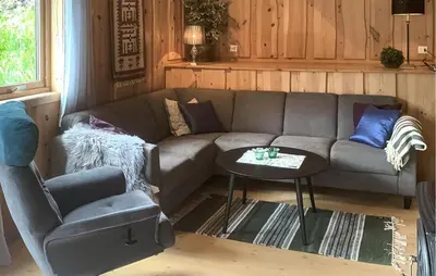 a living room with a couch and a chair at Stunning Home In Lauvstad With House Sea View in Lauvstad