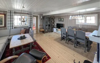 a living room with a couch and a table at 3 Bedroom Lovely Home In Sjusjøen in Sjusjøen